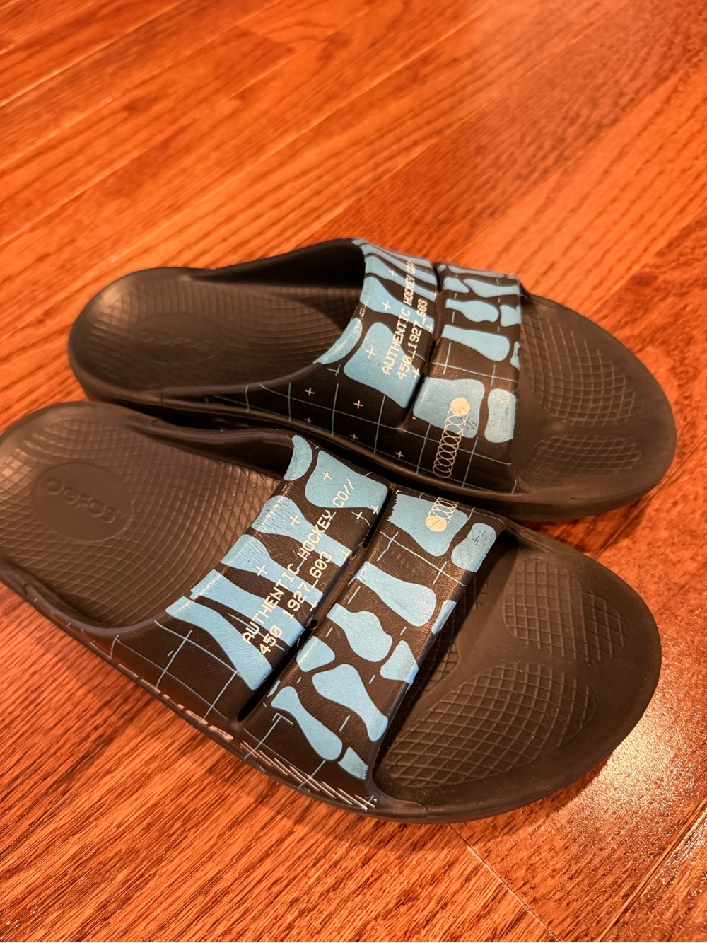 OOFOS Kids Black Slides with Light Blue Pattern